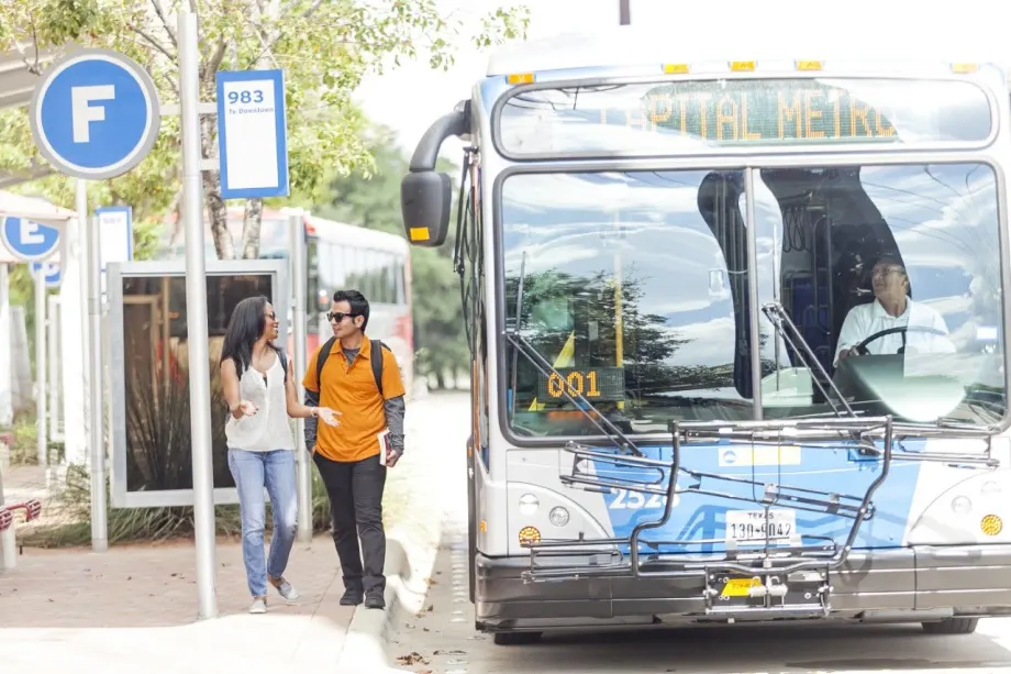 CapMetro customers at a bus stop/