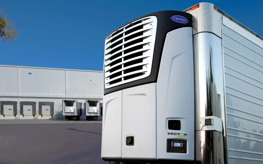Carrier Transicold electric transport refrigeration unit on stationary trailer with loading docks in the background