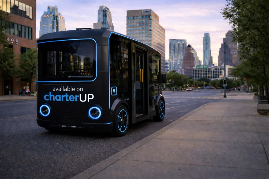 A black and blue HOLON urban autonomous vehicle on a city street.
