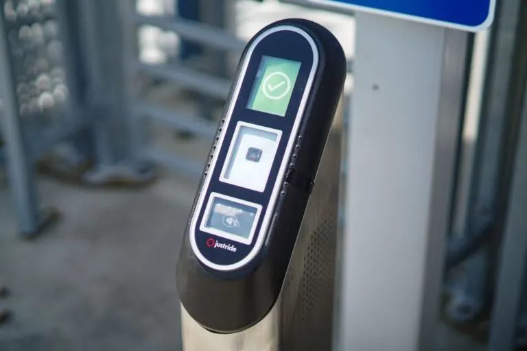 An image of a ticket validator in front of a security gate.