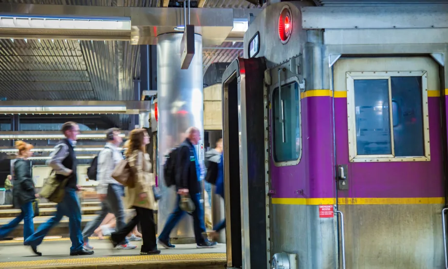 MBTA rail platform with people walking by.
