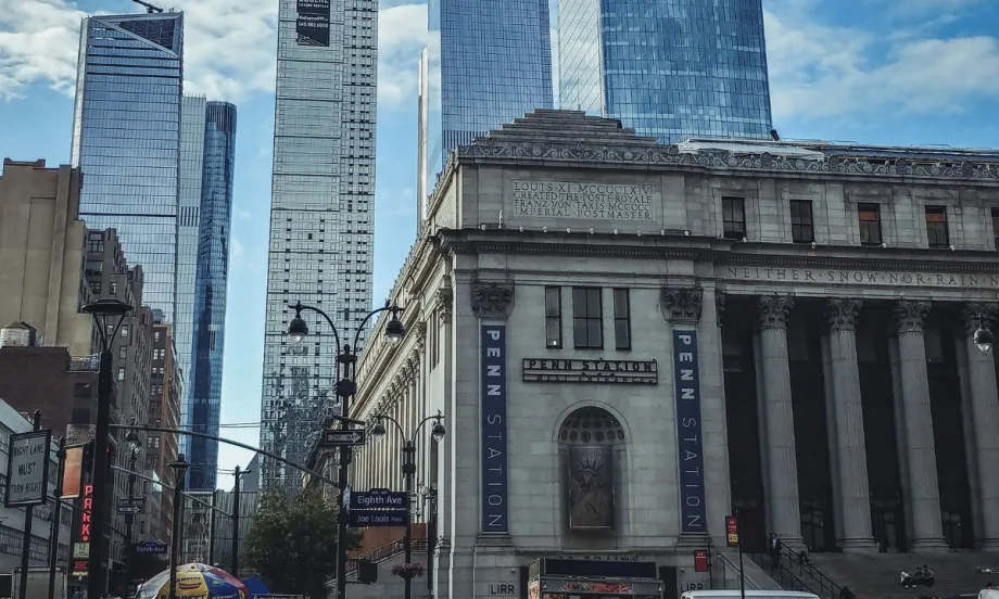A scene of Penn Station with Hudson Yards skyscrapers in the background in New York City.