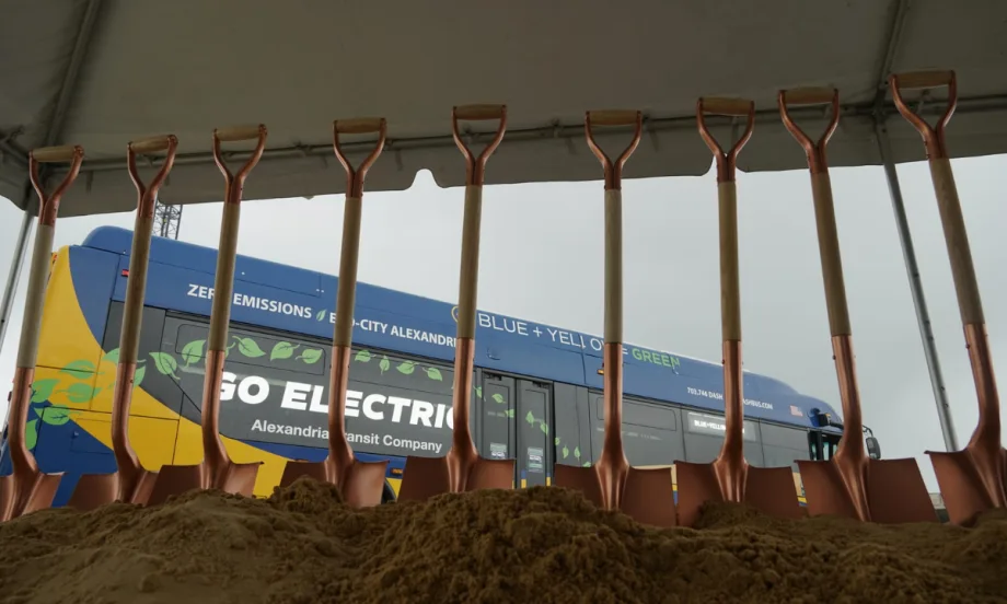 Shovels standing in dirt with a zero emissions bus in the background.