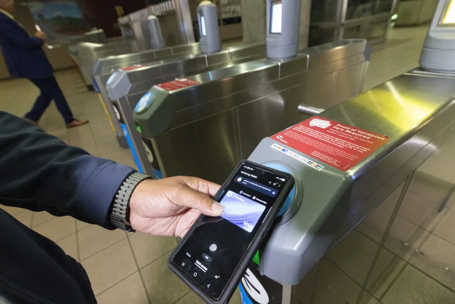 A person tapping their mobile card to ride LA Metro