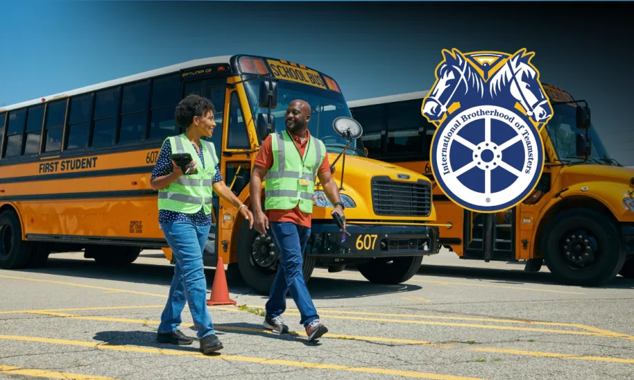 Two First Student drivers walking in front of school buses with a Teamsters logo in the foreground.