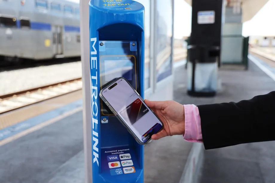 A user demonstrating Metrolink's contactless fare payment pilot.