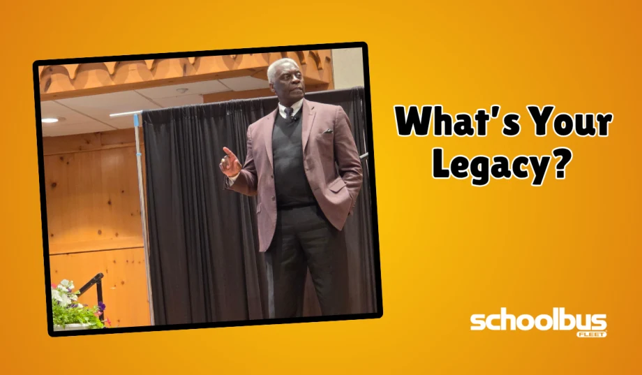 Nathanial “Coach” Hearne speaks onstage at a school transportation conference beside the words “What’s Your Legacy?” in a School Bus Fleet graphic.