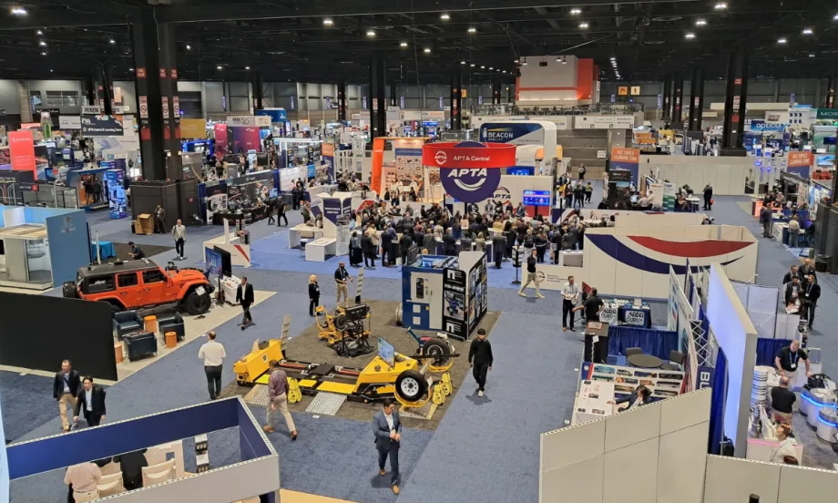 Overhead view of the APTA 2026 EXPO show floor at McCormick Place in Chicago, with attendees walking among exhibitor booths and gathering around APTA Central.