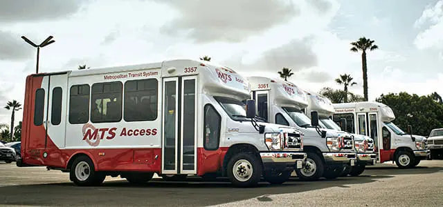 A lineup of four public transit vehicles.