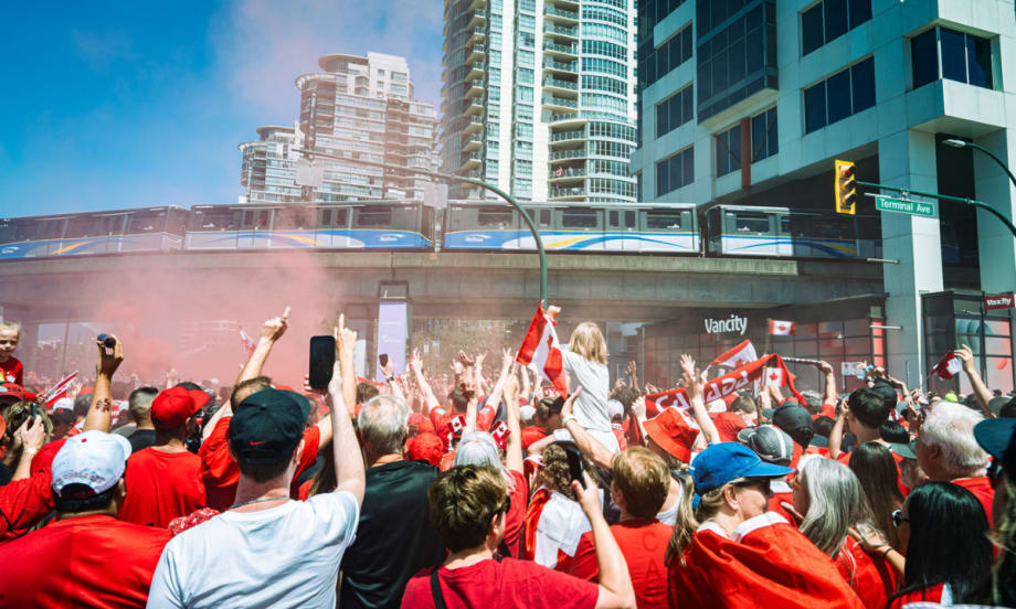 Canada-Qatar match fans underneath a TransLink SkyTrain overpass.