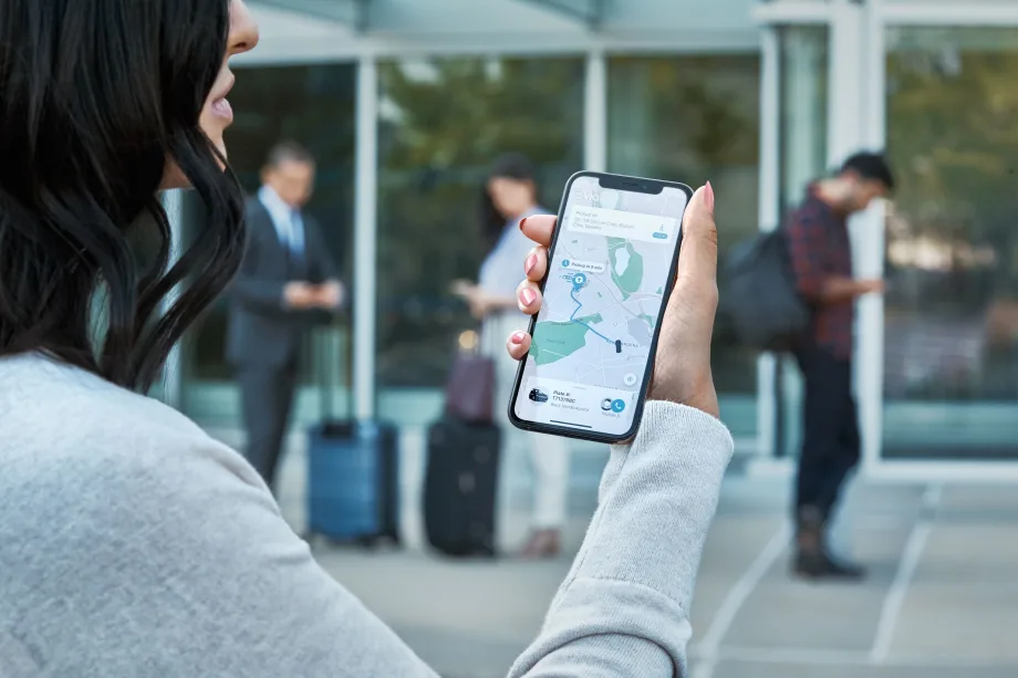 A rider looking at a Via map on a smartphone