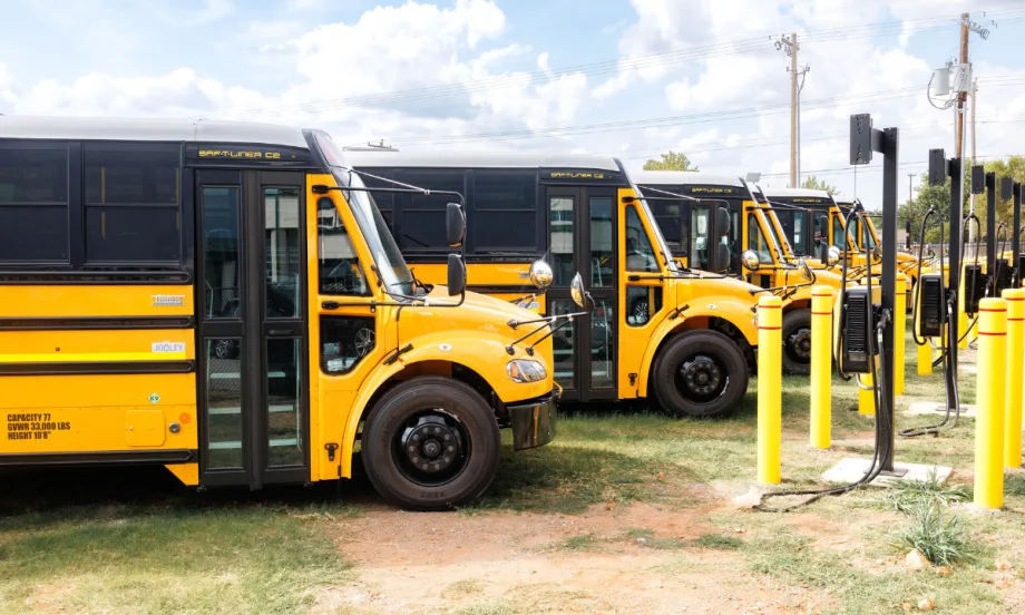 Electric buses parked at charging stations.