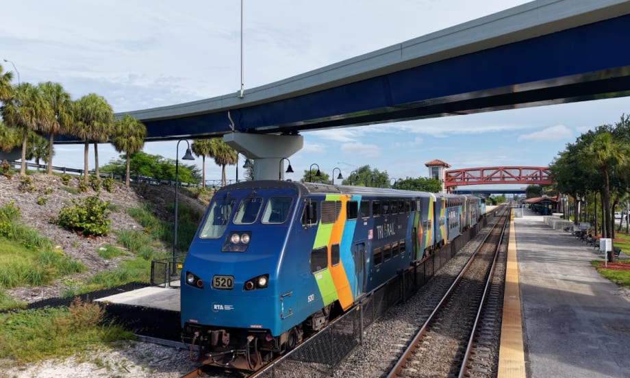 A light blue Tri-Rail at a station.