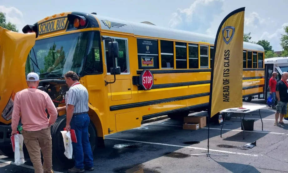 Attendees look at the engine of a bus at the 35th Annual Ohio School Bus Mechanics Association Workshop and Vendor Show.