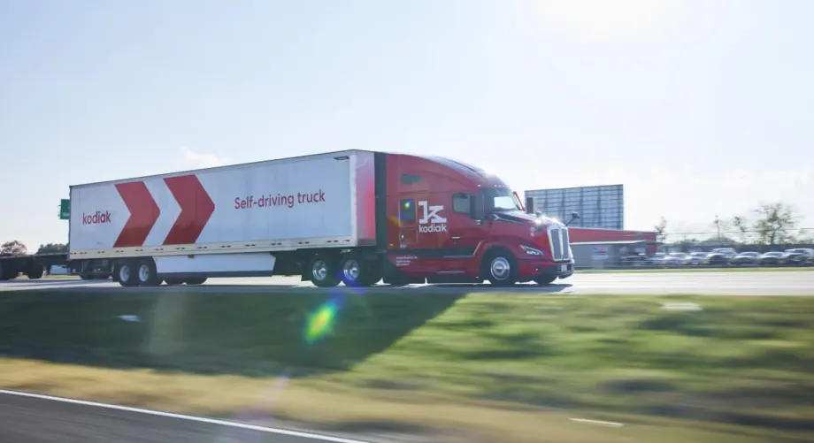 Red highway tractor pulling white trailer with red logo identifying Kodiak.
