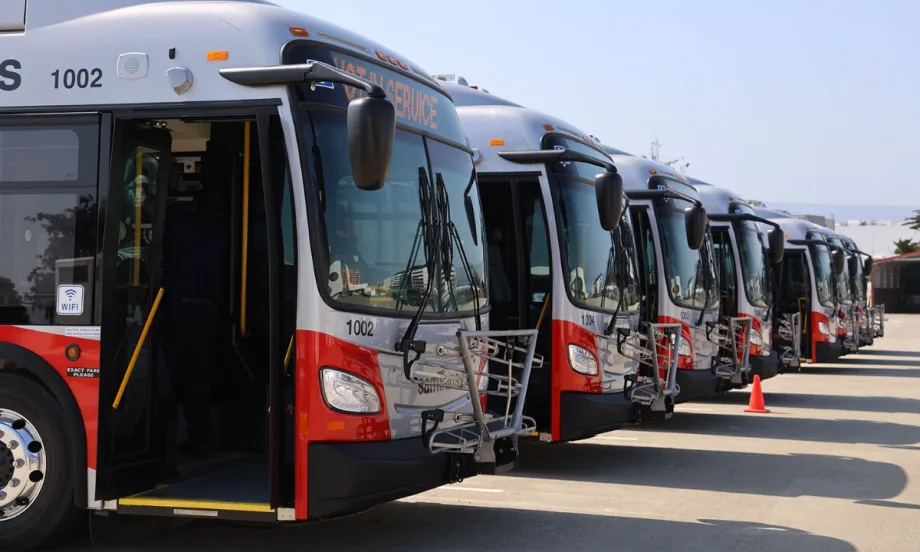 Multiple SamTrans public transit buses lined up.