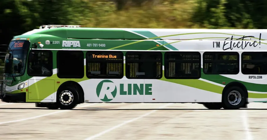 A green and white Rhode Island Public Transit Authority electric bus.