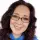 woman with glasses smiling