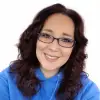 woman with glasses smiling